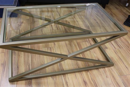A glass top coffee table on X frame W.120cm